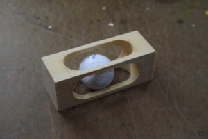 Golf Ball in a Block of Wood