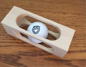 Golf Ball Inside a Block of Wood